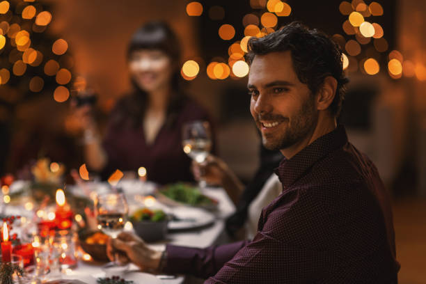 istock happy man having christmas dinner with friends 1418173834