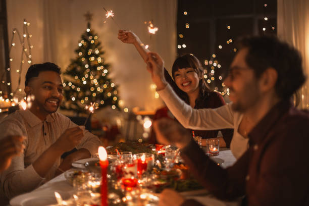 istock happy friends with sparklers at christmas dinner 1418174490