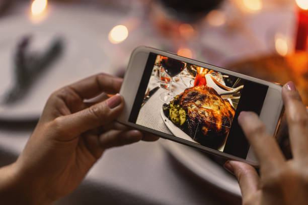 istock hands photographing food at christmas dinner 1418174821