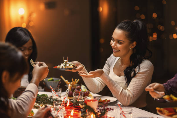 istock happy friends having christmas dinner at home 1418175301