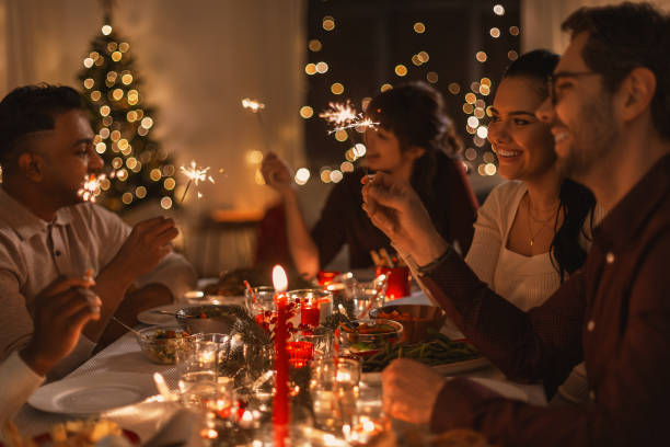 istock happy friends with sparklers at christmas dinner 1418176107