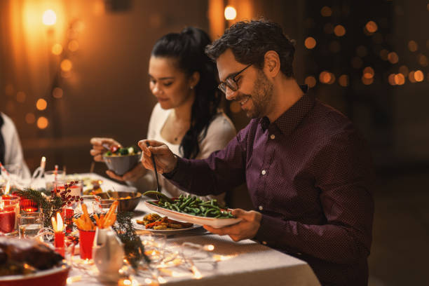 istock happy friends having christmas dinner at home 1418176257