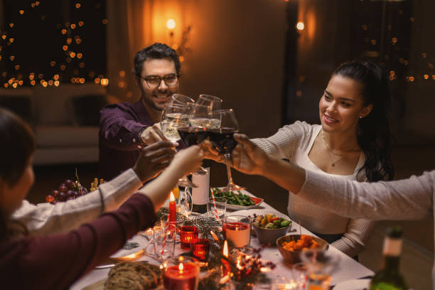 istock happy friends drinking wine at christmas party 1418176481