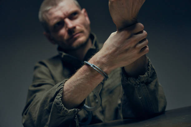 istock A prisoner after removing handcuffs a dark background in professional illumination 1418176482