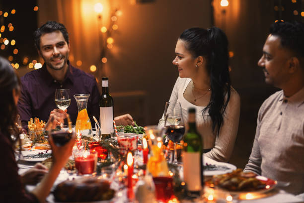 istock happy friends drinking wine at christmas party 1418176599