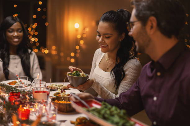 istock happy friends having christmas dinner at home 1418176659
