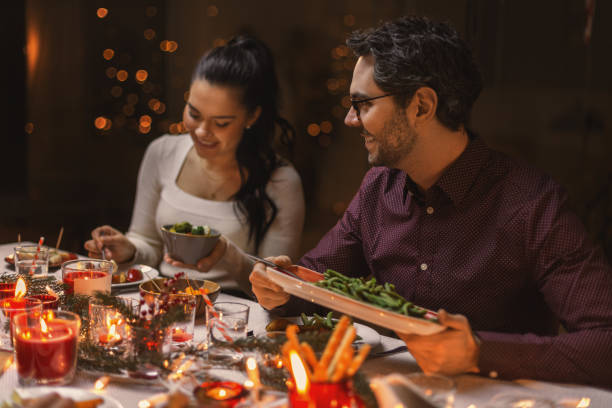 istock happy friends having christmas dinner at home 1418177097