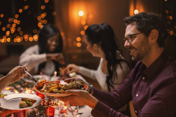 istock happy friends having christmas dinner at home 1418177327