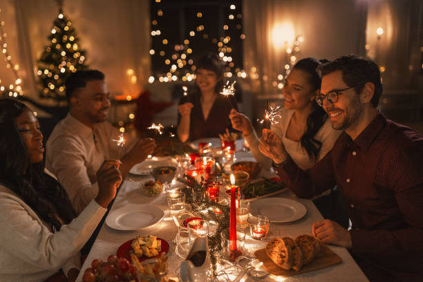 istock happy friends with sparklers at christmas dinner 1418178148