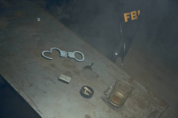 istock A fogged room for interrogations with empty cup, handcuffs and cigarette lighter on an old table 1418178199