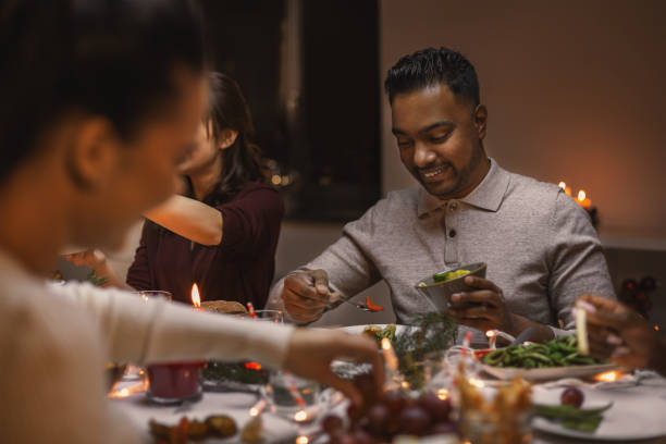 istock happy friends having christmas dinner at home 1418178246
