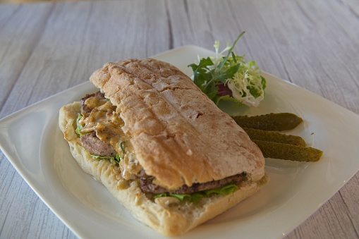 Nordic style hunter sandwich made for Italian style focaccia bread filled with beef and mushrooms with creamy sauce.
