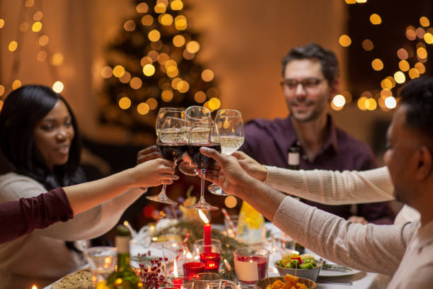 istock happy friends drinking wine at christmas party 1418178522