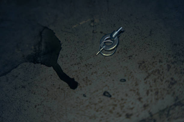 istock Tiny handcuffs keys on an old table of a floor 1418178587