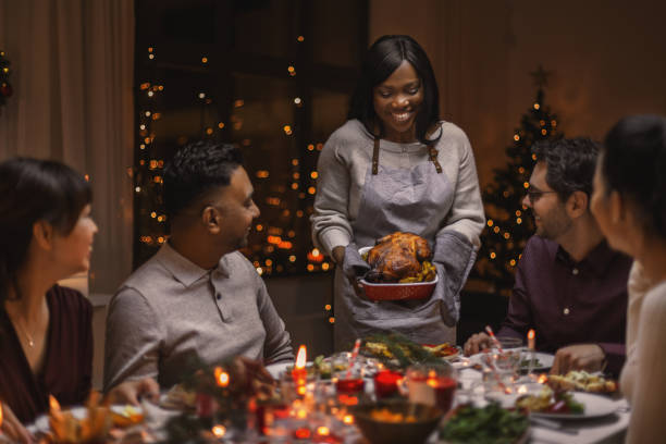 istock happy friends having christmas dinner at home 1418178640