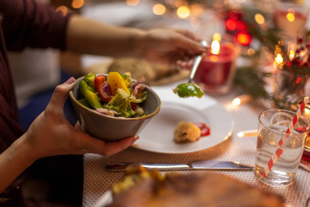 female hands with food at christmas dinner