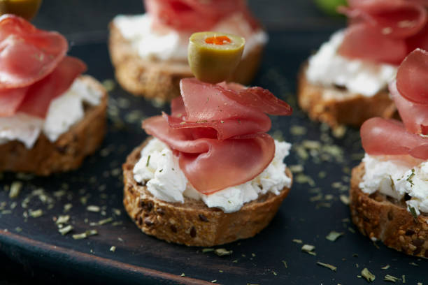 sanduíches pequenos com prosciutto, queijo e azeitonas - salumeria - fotografias e filmes do acervo