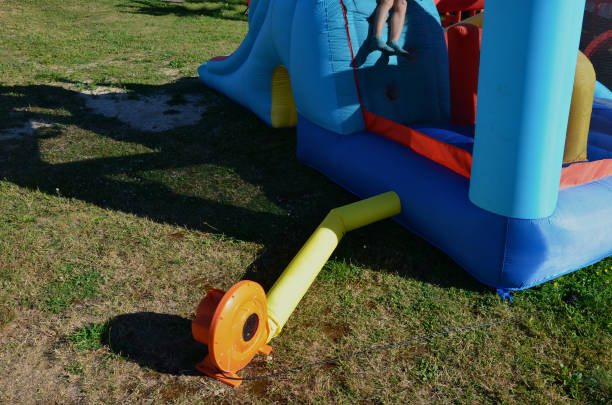 istock before inflating the bouncy castle attraction make sure blower is securely connectedelectricity and slide is anchored to the ground. otherwise there is a risk of electric shock or falling down, safety 1418183497