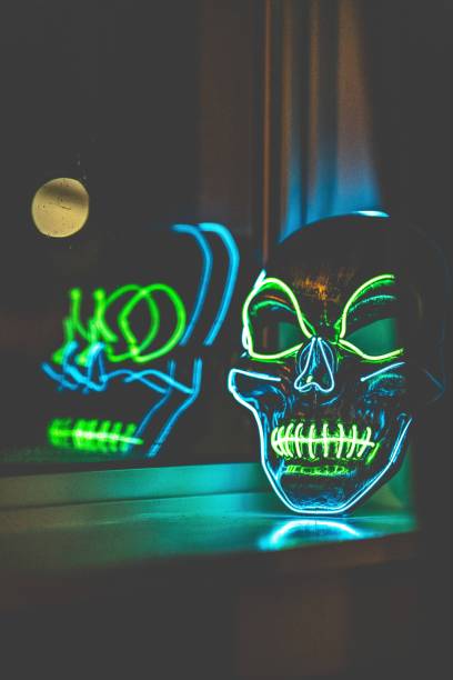 istock Vertical closeup of a skull mask with neon lights. 1418184577