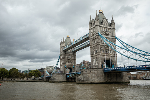 Tower Bridge with Thames river during oevercast day in London