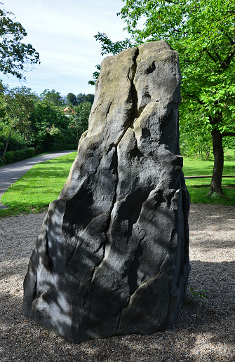 felt stone with surface treatment for training climbing. tooth-shaped boulder in a park in the city. an imitation of an adult-sized rock on a children's playground. there are crevices and grips , dent, teeth, felt, grip, mockup, pebbles, ragged