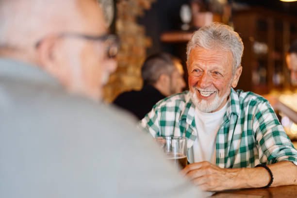istock Two senior friends enjoying beer in the pub 1418186467