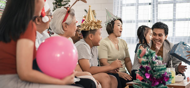 Big group of Asian family celebrate Christmas and new years party at home with happiness