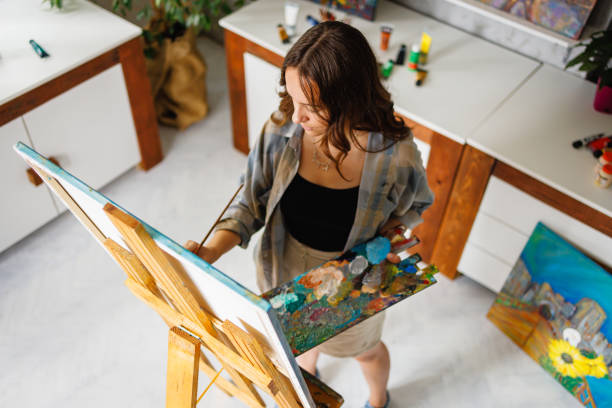 istock Artist painting on canvas in art studio 1418190409