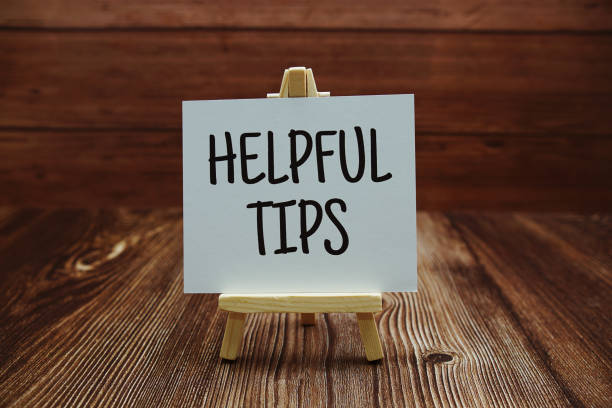 istock Helpful Tips text on paper card on wooden background 1418190830
