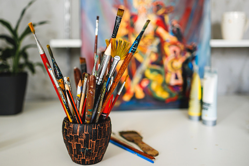 Paintbrushes on table in art studio