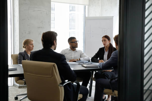 istock Concentrated diverse business people discussing working issues in office. 1418192875