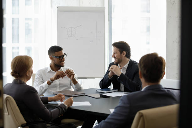 istock Happy relaxed multiracial business people talking in boardroom. 1418192882