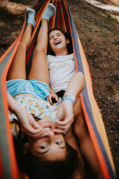 istock Two girls playing in the colorful hammock 1418192955