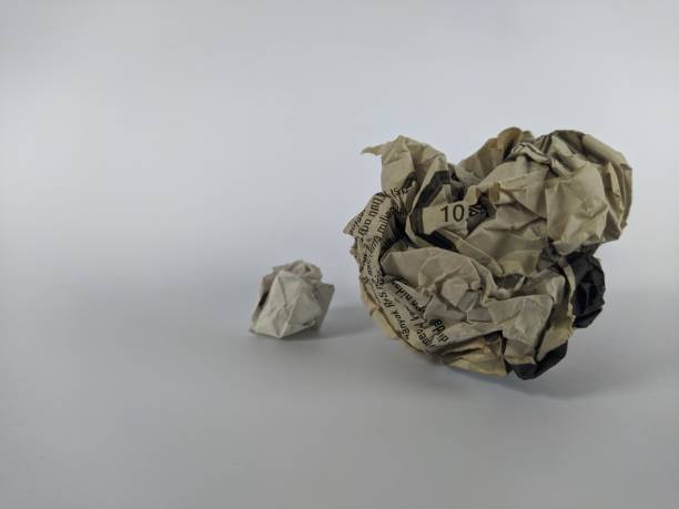 istock Crumpled wad of paper on a white background 1418195908