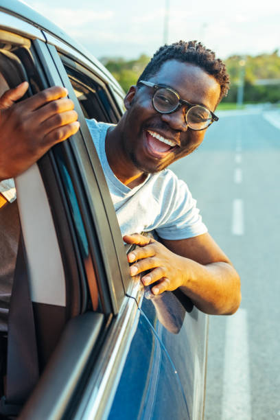 istock Man sticking head out of a car window 1418197727