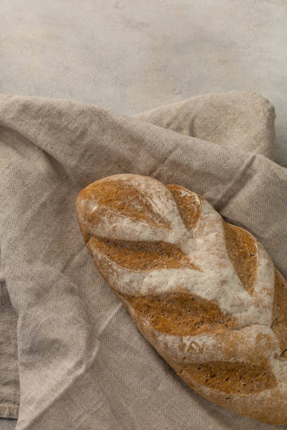istock Gluten free fresh bread in kitchen towel on light background 1418200699
