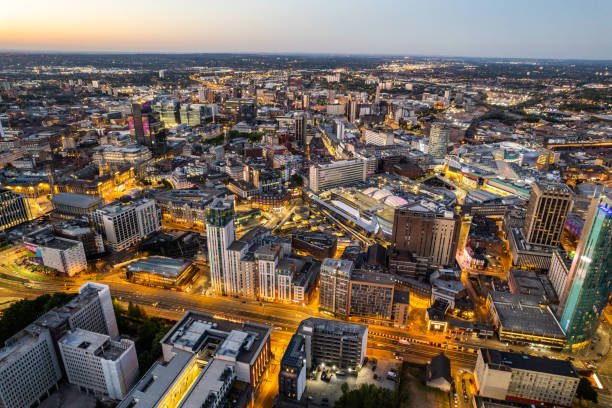 Birmingham United Kingdom Aerial view over the city center by night including central train station stock photo
