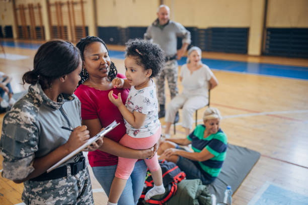 istock Soldier with civilians after natural disaster 1418205790