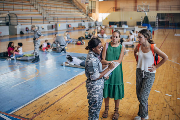 istock Soldier with civilians after natural disaster 1418207707