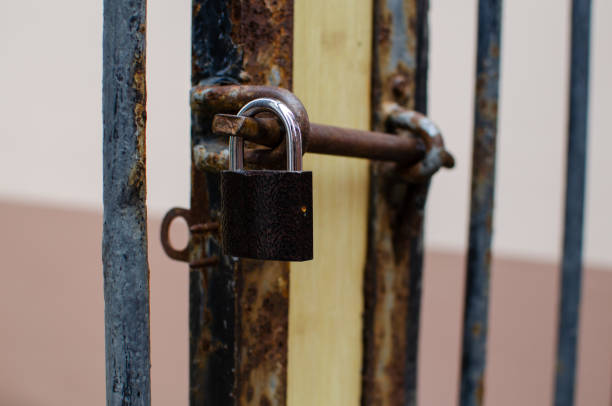 istock Vintage padlock. Closed gate to an old, rusty padlock. 1418209118