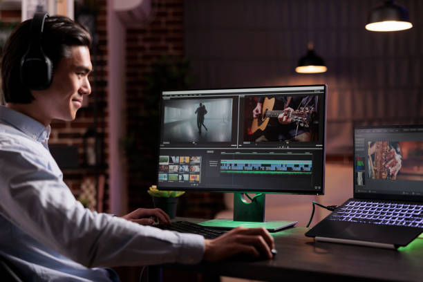 istock Male videographer editing movie footage 1418210653