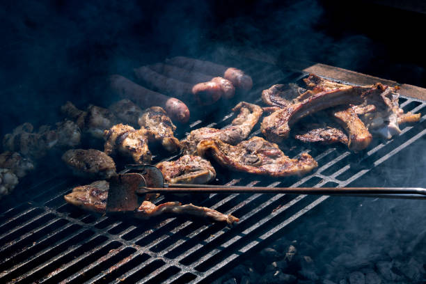 istock Grilled meat cooking on a wrought iron grill 1418210749