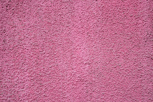 Vibrant pink (rose) plastered stucco wall texture