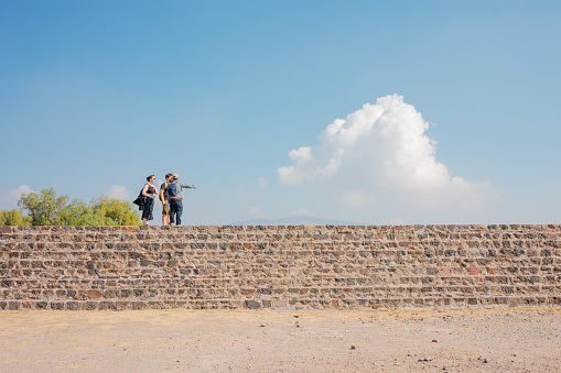 State of Mexico, Mexico; February 19 2022: tourists receiving directions on pre-Spanish stairs, architecture.