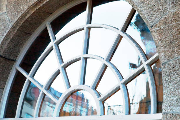 istock Above front door ancient fan shaped window,  fanlight, stone wall. 1418215713