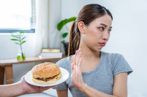 Healthy Asian women choose not to eat unhealthy food.