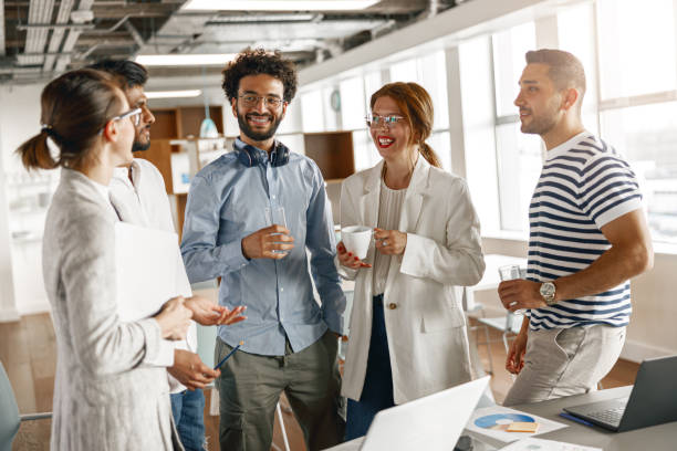 istock Diverse group of colleagues enjoying working together in an office. Teamwork concept 1418217343