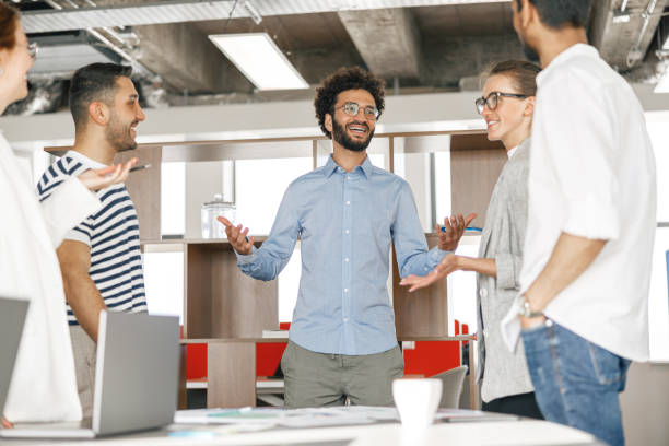 istock Diverse group of colleagues enjoying working together in an office. Teamwork concept 1418218477