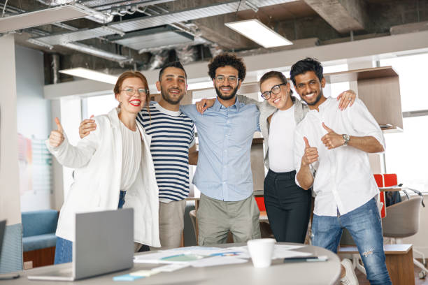 istock Diverse group of colleagues enjoying working together in an office. Teamwork concept 1418218562
