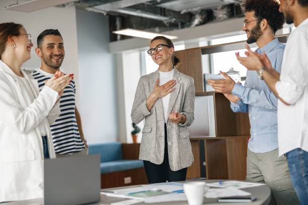 istock Diverse group of colleagues enjoying working together in an office. Teamwork concept 1418218588